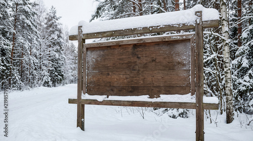 Blank Wooden Sign In Snowy Forest Landscape At Winter