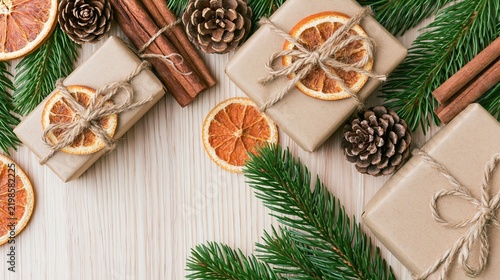 Christmas kraft gift boxes with dried oranges, cinnamon and fir branches