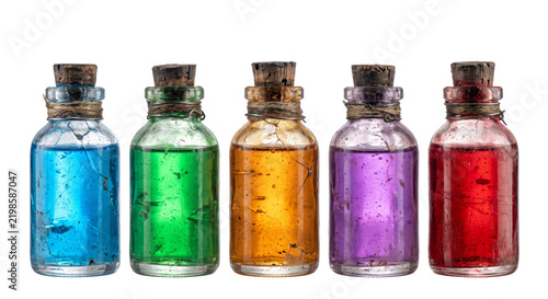 Картината върху платно Five vintage glass bottles with colorful liquid potions and cork stoppers on whi