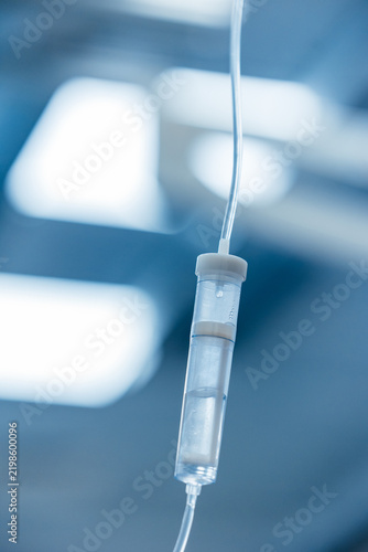 Картината върху платно IV drip chamber close up with saline solution dripping, intravenous infusion in