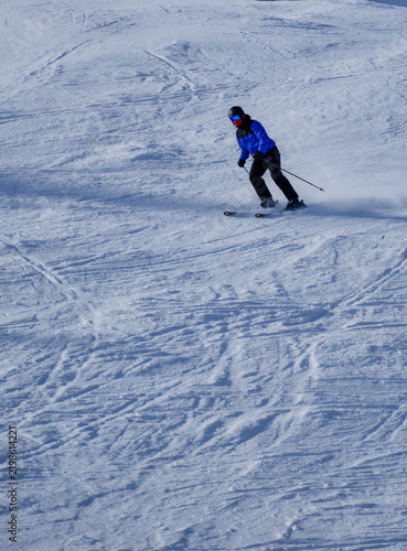 Bild auf Leinwand Skier carving a turn on a piste at Zell am See Austria