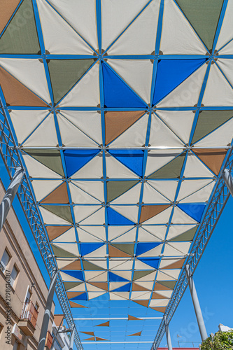 Colorful shade canopies over pedestrian street in Chipiona, Spain
