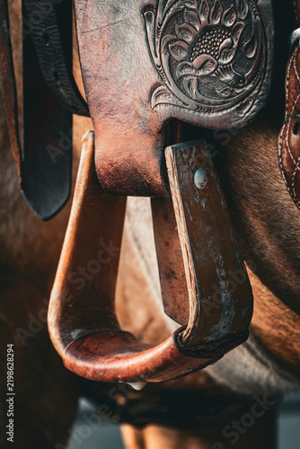 closeup of a leather western saddle stirrup