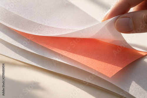 Hidden Red Paper Revealed Between White Sheets