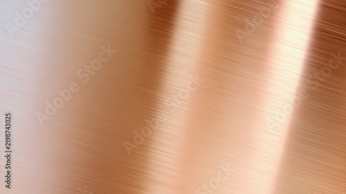 Polished metallic surface displays subtle brushed texture and warm light reflections.