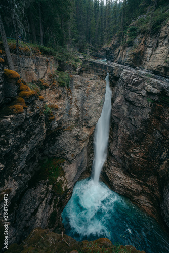 Fotografie View down onto the Upper Falls of Johnston Canyon churning into a turquoise plun