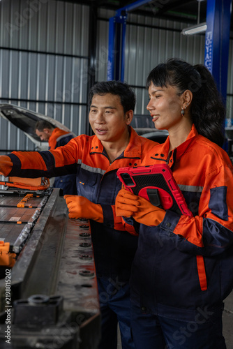 Industrial worker female engineer male technician factory machinery safety uniform tablet teamwork in industrial factory environment