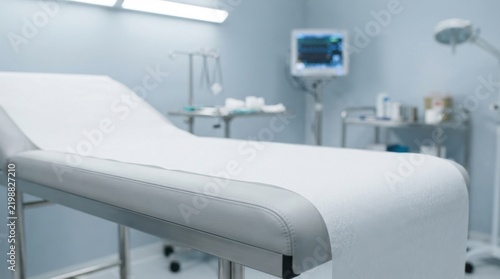 Modern hospital examination room featuring medical bed clinical equipment and advanced healthcare technology in a sterile facility