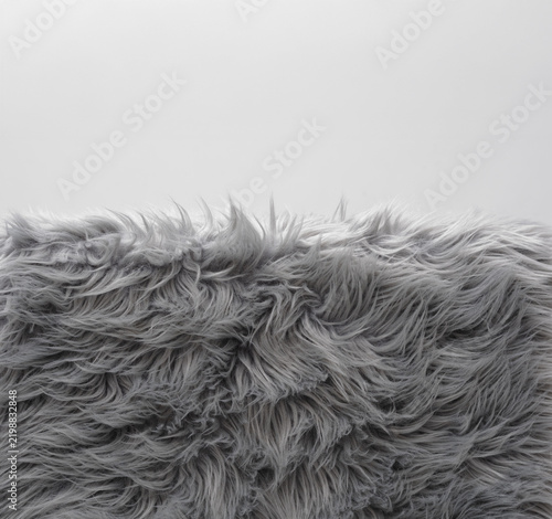 Soft grey faux fur carpet pile with copyspace background for home decor