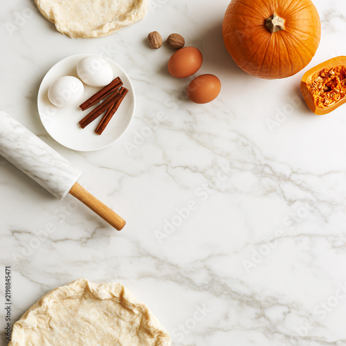 Ingredients for making pumpkin pie arranged on a kitchen counter
