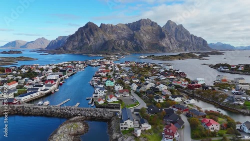 Famous football field in Henningsvær with dramatic mountain backdrop. Lofoten Norway aerial drone. 4K.