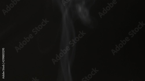 White smoke billows gently against a dark background.