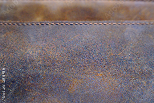 Close-up view of aged leather material with visible stitching