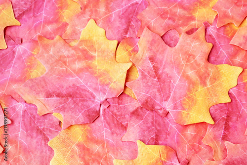 Top view of multicolor paper napkin background in the shape of a plane tree leaf.