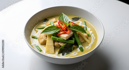 Thai Green Curry Bowl: A steaming bowl of authentic Thai green curry, brimming with tender chicken, crisp bamboo shoots, and vibrant green beans, artfully garnished with fresh basil and chili slices.