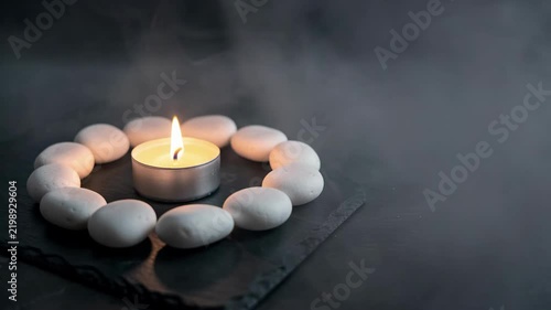 Zen Candle With Pebbles On Dark Slate.
