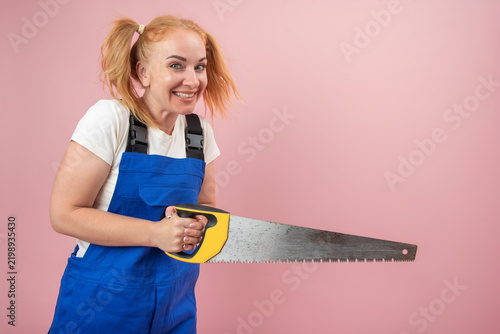Fotografie Smiling woman with fiery pigtails wearing blue overalls and a white t shirt