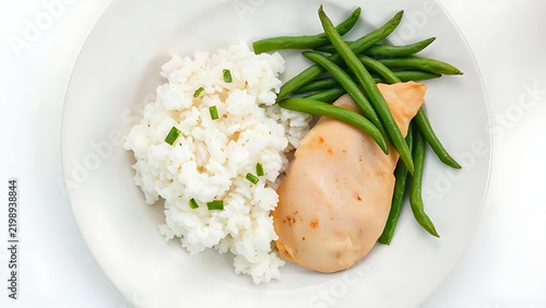 Flavorless bland diet meal, plain white plate with steamed rice, boiled chicken breast and unsalted green beans