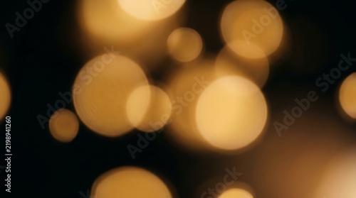 Golden bokeh light circles on black background