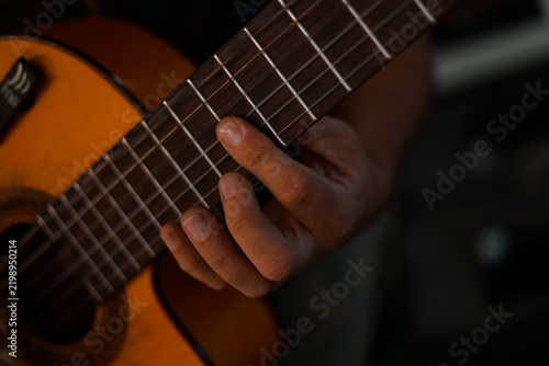 Playing the guitar. Close up. 