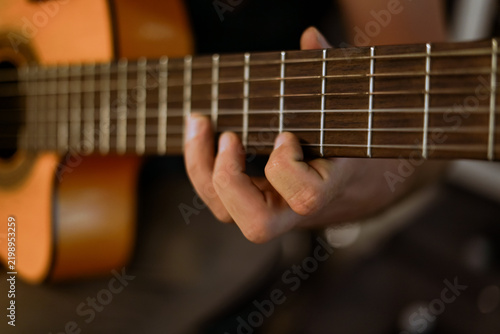 Playing the guitar. Close up. 