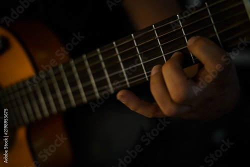 Playing the guitar. Close up. 