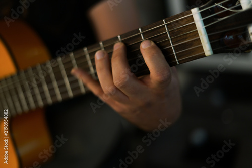 Playing the guitar. Close up. 