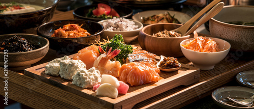 A vibrant spread of delicious food laid out on a table, featuring fresh seafood, vegetables, and various side dishes, ready to be enjoyed.