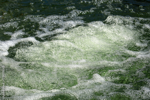 Fotografie Bubbling Green Water Surface with White Foam