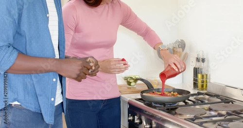 Lifestyle videos indoor of people doing activities at home, cooking together, couple seasoning veget
