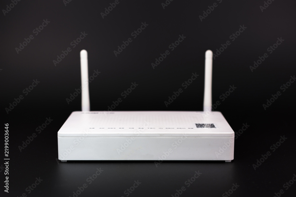 Fototapeta premium White wireless router with two antennas on dark background