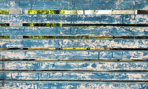 Abstract rustic blue wooden fence background with peeling paint texture.