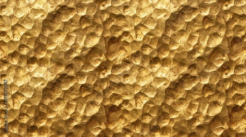 A high resolution seamless texture of hammered gold metal featuring a detailed bumpy surface with reflective yellow highlights and deep shadows that create a luxury metallic background