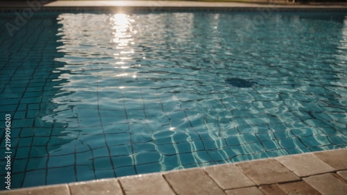 View of Water Surface in Swimming Pool With Tile Edges in the Afternoon Sun