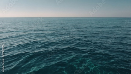 Calm Blue Ocean Waves Under a Clear Sky in a Tropical Location