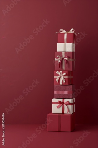 Colorful Stacked Gift Boxes on a Red Background for a Festive Occasion