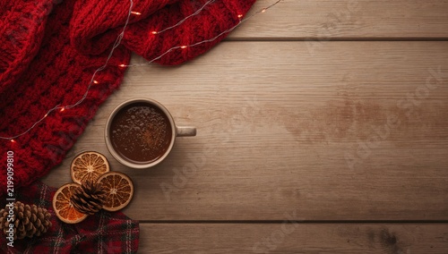 Warm Coffee Cup Surrounded by Cozy Items and Decorative Elements on Wooden Su...