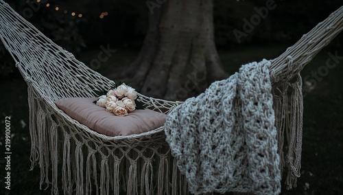 Hammock With Flowers and Blanket in a Garden During Evening Time