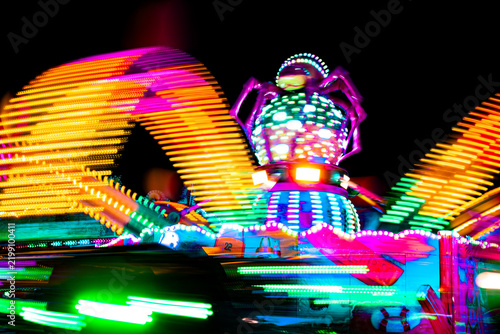 Colorful Long Exposure Light Trails of a Spinning Carnival Ride at Night