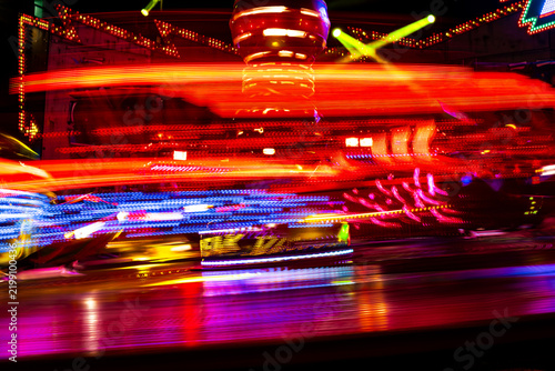 Abstract Motion Blur of a Fast Moving Colorful Carnival Ride at Night