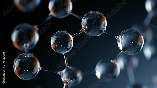 Transparent glass molecular structure model with connected spheres and glowing light reflections on dark background   