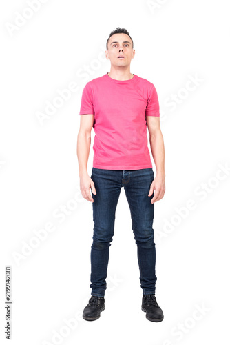 Quadro su tela Full length astonished male in jeans and pink t shirt opening mouth and looking