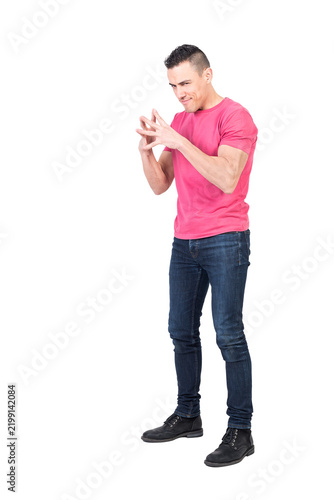 Foto Full length of cunning young man with dark hair in t shirt and jeans connecting