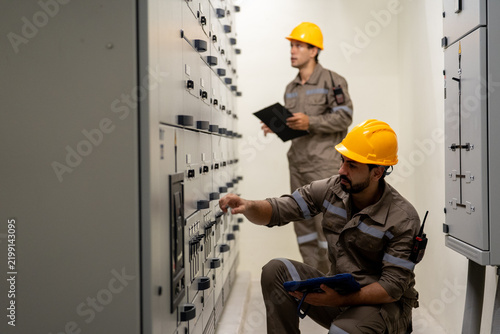 Canvastavla Industrial engineer inspecting electrical control panel in power facility while