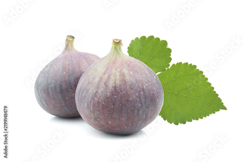Two fresh figs with leaf isolated on white