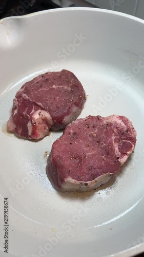 Savoring fresh raw beef tenderloin steak cuts brings culinary joy to home cooking prep using clean white skillet pan for delicious, savory protein dinner meals, promising passionate gourmet taste