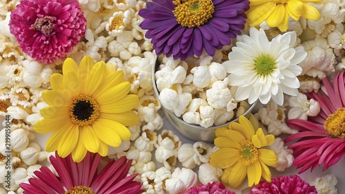 A colorful bouquet of pink, yellow, orange, and purple gerberas and daisies in a spring garden—a vibrant floral arrangement featuring popcorn.