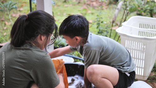 Thai woman and child using smartphone together happy family