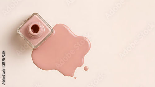 Pink Nude Nail Polish Bottle Spilled Liquid Swatch on Cream Background