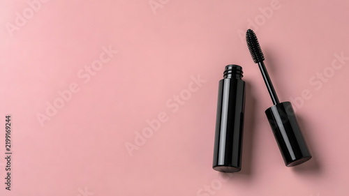 Black Mascara Wand and Tube Isolated on Pink Background for Eye Makeup Concept